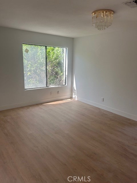 171 Junipero Serra Dr Unit D, San Gabriel, CA 91776 - unfurnished room featuring wood finished floors, baseboards, and a chandelier