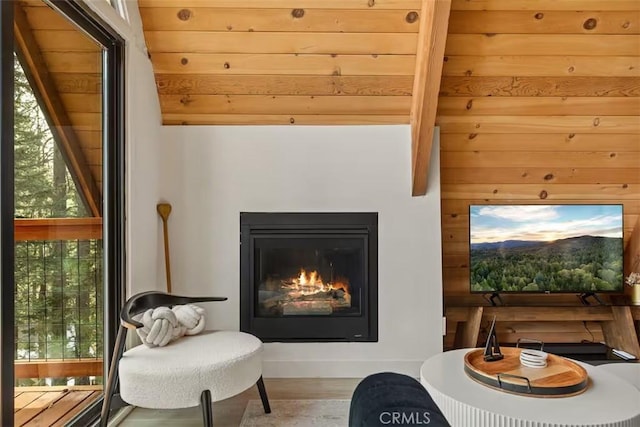 26664 Thunderbird Dr, Lake Arrowhead, CA 92391 - sitting room with plenty of natural light, wood finished floors, wood walls, and a glass covered fireplace