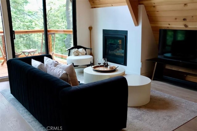 26664 Thunderbird Dr, Lake Arrowhead, CA 92391 - living room featuring lofted ceiling, wood finished floors, wooden ceiling, and a glass covered fireplace
