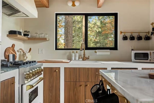 26664 Thunderbird Dr, Lake Arrowhead, CA 92391 - kitchen with white microwave, a sink, gas range oven, and brown cabinets