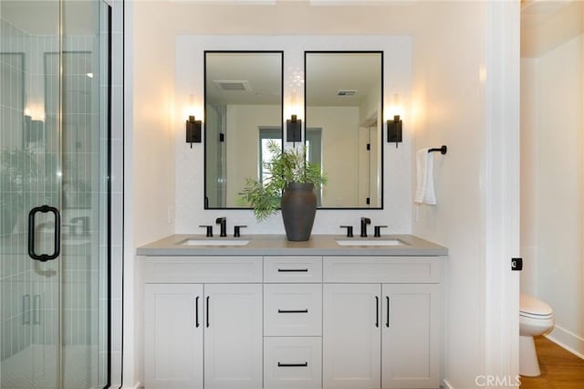 414 Main Unit 200, Huntington Beach, CA 92648 - bathroom featuring a shower stall, toilet, and double vanity