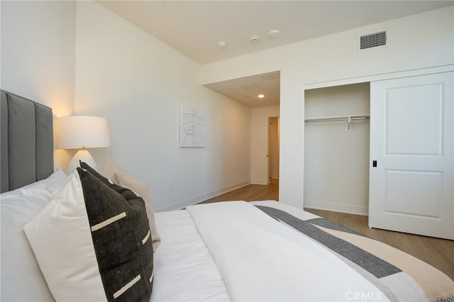 414 Main Unit 200, Huntington Beach, CA 92648 - bedroom featuring wood finished floors, a closet, baseboards, and recessed lighting