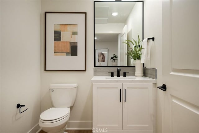414 Main Unit 200, Huntington Beach, CA 92648 - bathroom featuring toilet, baseboards, and vanity
