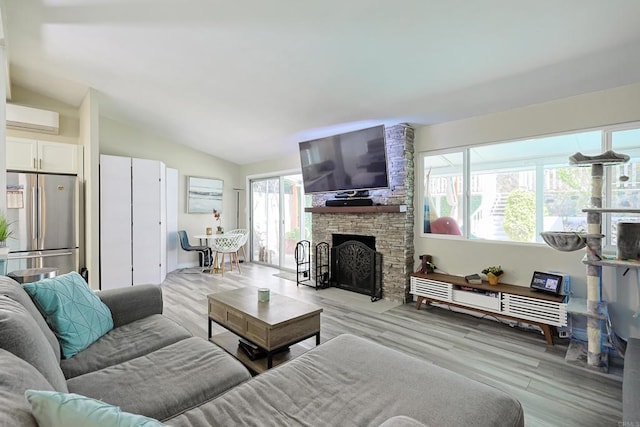 6683 Ballinger Ave, San Diego, CA 92119 - living area with lofted ceiling, light wood-type flooring, a wall mounted AC, and a fireplace