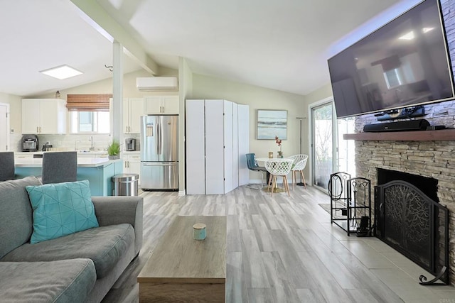 6683 Ballinger Ave, San Diego, CA 92119 - living area with light wood-type flooring, a wall unit AC, and a fireplace