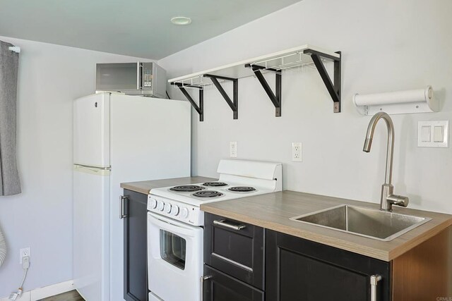 6683 Ballinger Ave, San Diego, CA 92119 - kitchen with white appliances and dark cabinets