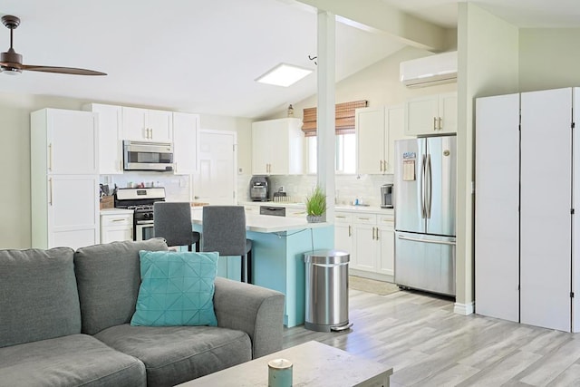 6683 Ballinger Ave, San Diego, CA 92119 - kitchen featuring appliances with stainless steel finishes, open floor plan, light wood finished floors, and light countertops