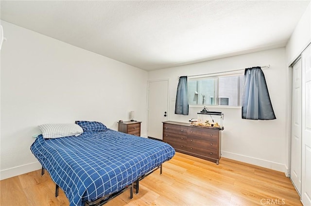 1108 Camino Real Unit 306, Redondo Beach, CA 90277 - bedroom with baseboards, wood finished floors, and a closet