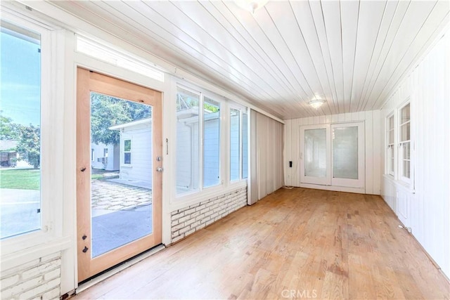unfurnished sunroom featuring wood finished floors and wooden ceiling