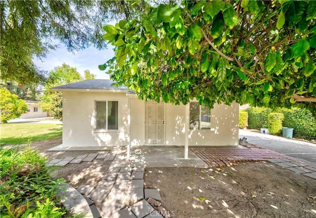 back of house with stucco siding