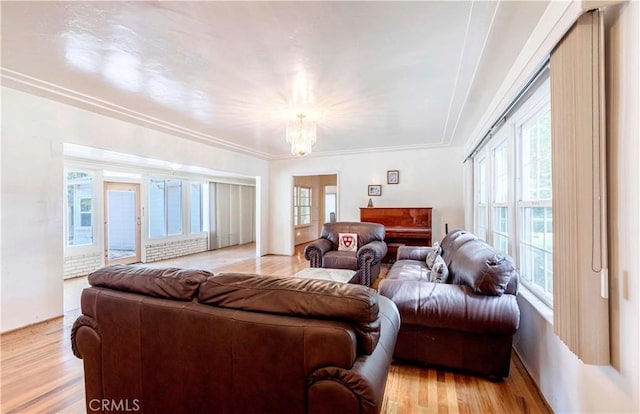 living area with a chandelier and light wood-style flooring
