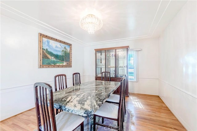 dining room featuring a chandelier and light wood-type flooring