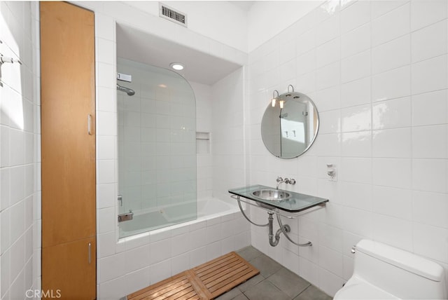 1601 Kent Ln, Newport Beach, CA 92660 - bathroom with tile walls, toilet, tile patterned flooring, and tiled shower / bath