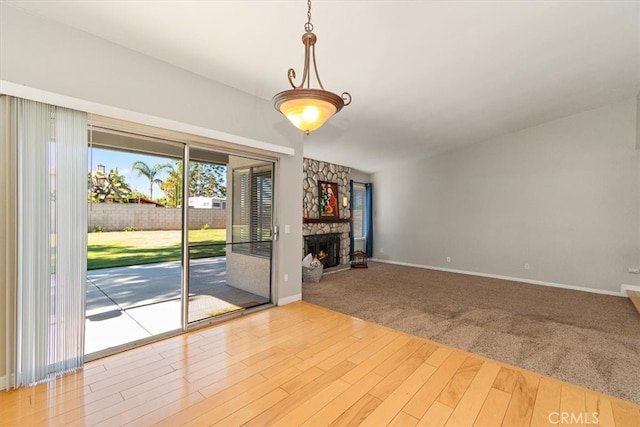 168 Radford Ct, Riverside, CA 92507 - empty room with wood finished floors, baseboards, a fireplace, and carpet floors