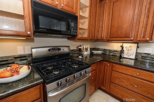 168 Radford Ct, Riverside, CA 92507 - kitchen featuring gas range, black microwave, brown cabinetry, decorative backsplash, and dark stone countertops