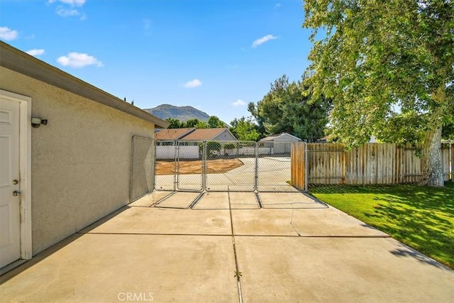 168 Radford Ct, Riverside, CA 92507 - view of patio featuring a mountain view and a gate