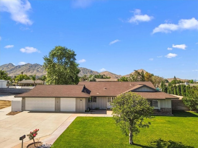 168 Radford Ct, Riverside, CA 92507 - ranch-style house with board and batten siding, an attached garage, driveway, and a front yard