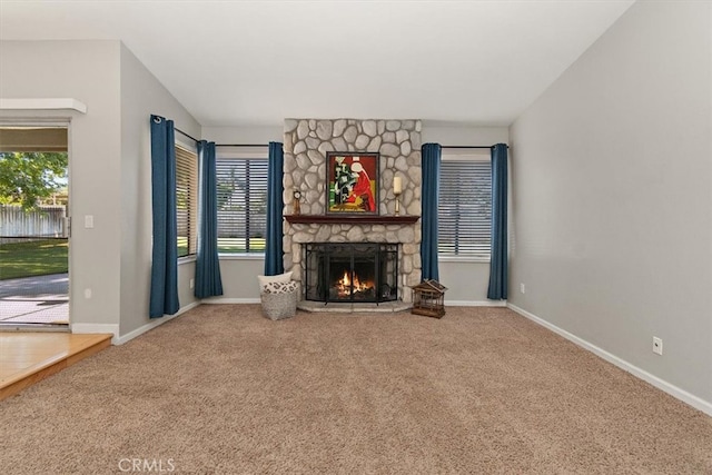 168 Radford Ct, Riverside, CA 92507 - unfurnished living room featuring carpet, a stone fireplace, and baseboards