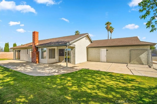 168 Radford Ct, Riverside, CA 92507 - rear view of property with stucco siding, a chimney, and a patio area