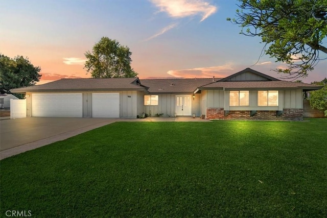 168 Radford Ct, Riverside, CA 92507 - single story home featuring board and batten siding, a garage, concrete driveway, a front yard, and a shingled roof