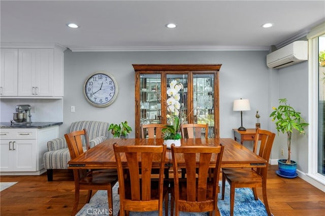 16422 Harbour Ln Unit 17, Huntington Beach, CA 92649 - dining space featuring a wall unit AC, crown molding, light wood-type flooring, and recessed lighting