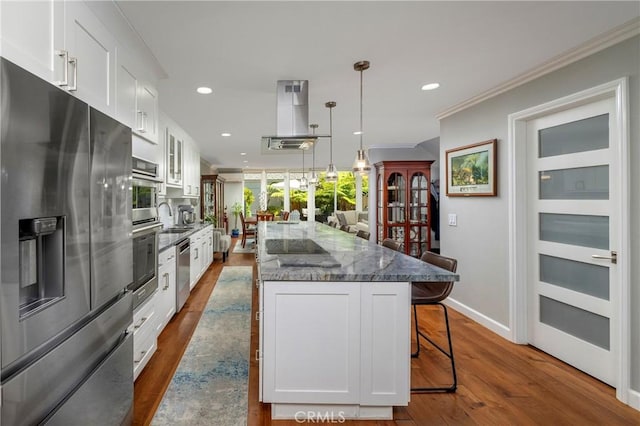 16422 Harbour Ln Unit 17, Huntington Beach, CA 92649 - kitchen with appliances with stainless steel finishes, island range hood, a kitchen bar, dark wood-type flooring, and white cabinetry