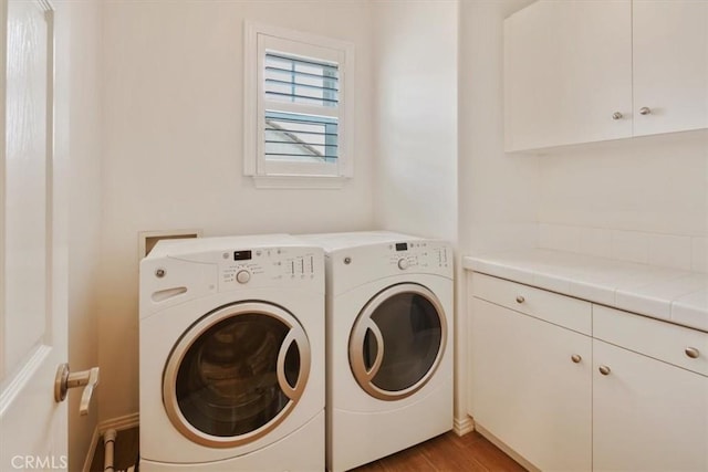 27086 Maple Tree Ct, Valencia, CA 91381 - laundry room with washing machine and dryer, cabinet space, and wood finished floors