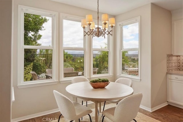 27086 Maple Tree Ct, Valencia, CA 91381 - dining area featuring baseboards, a chandelier, and wood finished floors