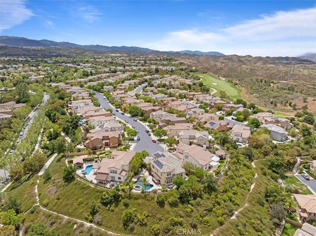 27086 Maple Tree Ct, Valencia, CA 91381 - aerial overview of property's location with a mountainous background, a pool, and nearby suburban area