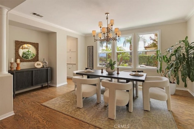 27086 Maple Tree Ct, Valencia, CA 91381 - dining space with wood finished floors, ornate columns, a chandelier, baseboards, and crown molding