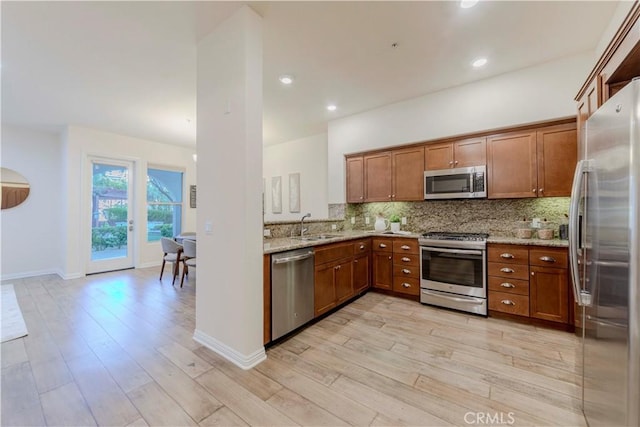 28220 Highridge Rd Unit 104, Rancho Palos Verdes, CA 90275 - kitchen with stainless steel appliances, brown cabinets, a sink, light wood-style floors, and recessed lighting