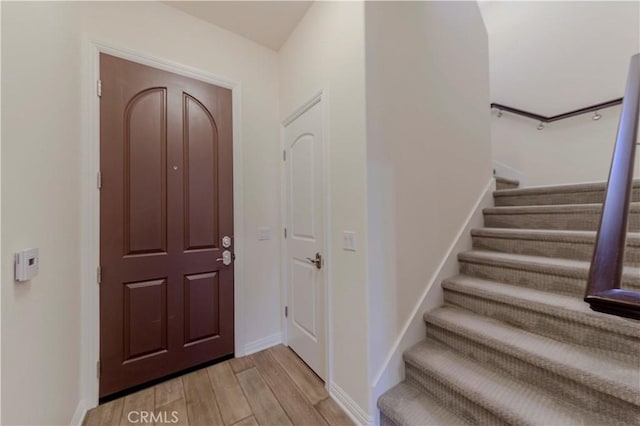 28220 Highridge Rd Unit 104, Rancho Palos Verdes, CA 90275 - foyer entrance featuring light wood-style flooring, stairway, and baseboards
