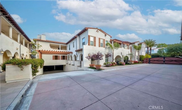 28220 Highridge Rd Unit 104, Rancho Palos Verdes, CA 90275 - rear view of property with a gate, stucco siding, a tiled roof, and a residential view