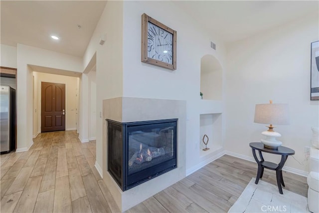 28220 Highridge Rd Unit 104, Rancho Palos Verdes, CA 90275 - living area with wood finished floors, baseboards, built in shelves, recessed lighting, and a multi sided fireplace