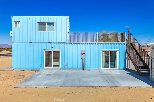 72473 Desert Trail Dr Unit 29, Palms, CA 92277 - rear view of property featuring a patio area and board and batten siding