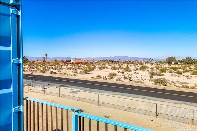 72473 Desert Trail Dr Unit 29, Palms, CA 92277 - water view with a mountainous background, fence, and a desert landscape