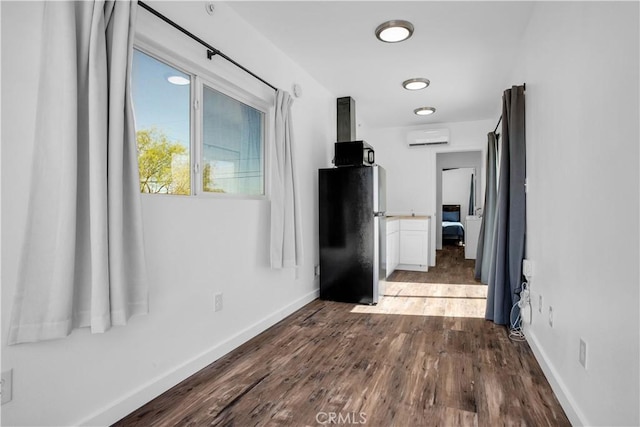 72473 Desert Trail Dr Unit 29, Palms, CA 92277 - hall featuring a wall mounted air conditioner, dark wood-style flooring, and baseboards