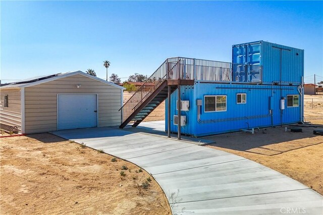 72473 Desert Trail Dr Unit 29, Palms, CA 92277 - view of outdoor structure featuring driveway, an outbuilding, and stairs