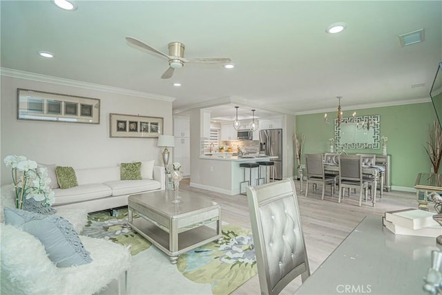 3365 Punta Alta Unit 3C, Laguna Woods, CA 92637 - living room featuring light wood-type flooring, ornamental molding, a ceiling fan, recessed lighting, and baseboards