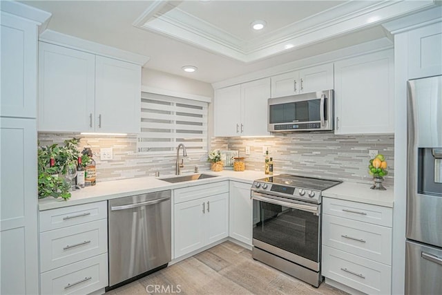 3365 Punta Alta Unit 3C, Laguna Woods, CA 92637 - kitchen with stainless steel appliances, a sink, ornamental molding, light countertops, and light wood finished floors