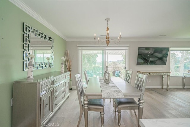 3365 Punta Alta Unit 3C, Laguna Woods, CA 92637 - dining area with a chandelier, light wood-type flooring, crown molding, and baseboards