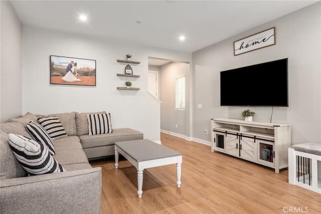 16073 Narni Ln, Fontana, CA 92336 - living area with light wood finished floors, baseboards, and recessed lighting