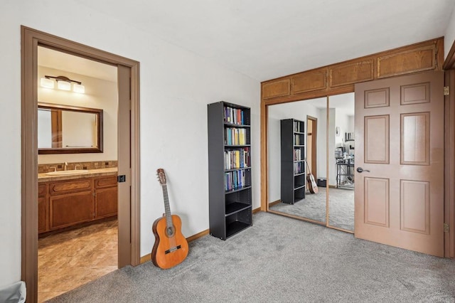 3631 Alta Vista Dr, Fallbrook, CA 92028 - bedroom with light colored carpet, a sink, a closet, connected bathroom, and baseboards