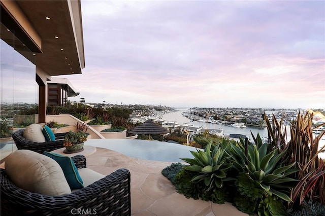 1131 Dolphin Ter, Corona Del Mar, CA 92625 - patio terrace at dusk with a water view and view of marina