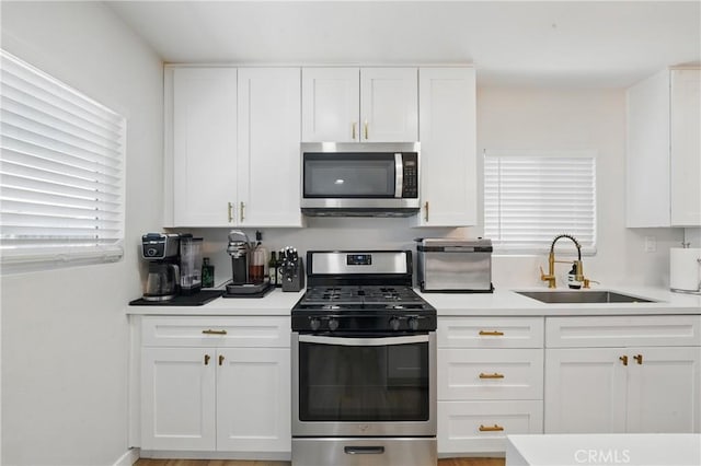 1343 Cordon Dr, City Terrace, CA 90063 - kitchen featuring appliances with stainless steel finishes, white cabinets, and light countertops