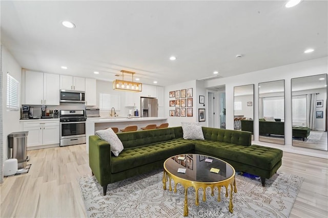 1343 Cordon Dr, City Terrace, CA 90063 - living area featuring plenty of natural light, light wood-style floors, recessed lighting, and a chandelier