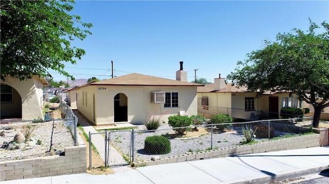 16754 Merrill St, Victorville, CA 92395 - view of front of home featuring a gate, stucco siding, and a chimney
