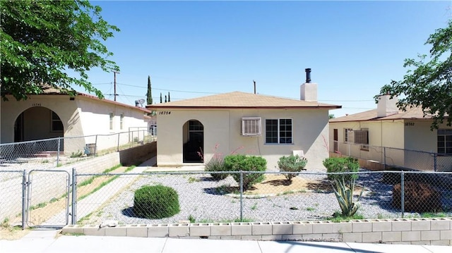 16754 Merrill St, Victorville, CA 92395 - view of front of home with stucco siding, a gate, and a chimney