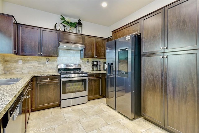 16759 Yellow Fern Ln, Fontana, CA 92336 - kitchen featuring stainless steel appliances, under cabinet range hood, decorative backsplash, light stone counters, and dark brown cabinetry