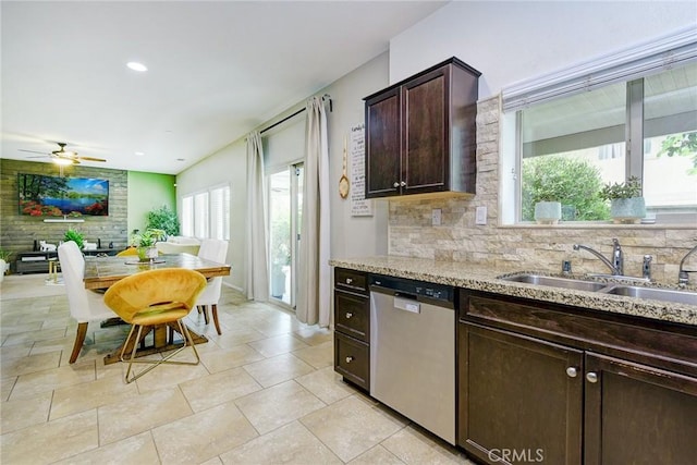16759 Yellow Fern Ln, Fontana, CA 92336 - kitchen with dishwasher, a sink, dark brown cabinetry, decorative backsplash, and light stone counters